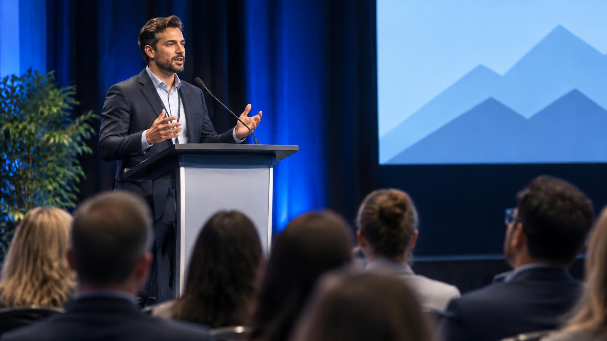 man giving persuasive speech on stage